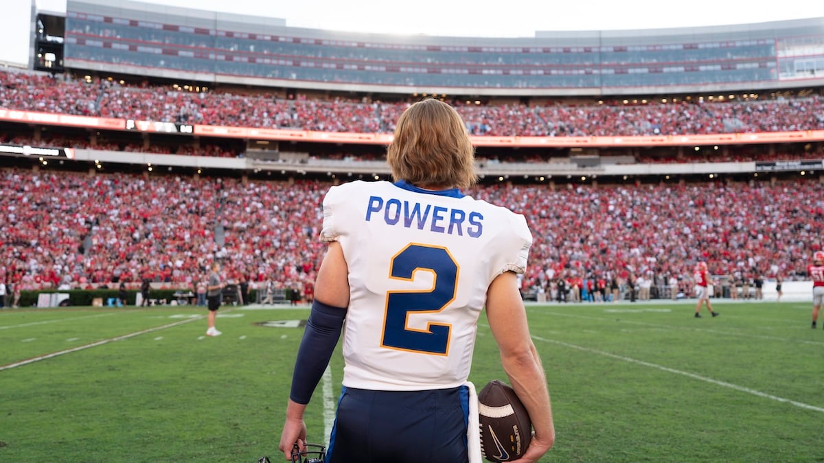 man standing in football standium