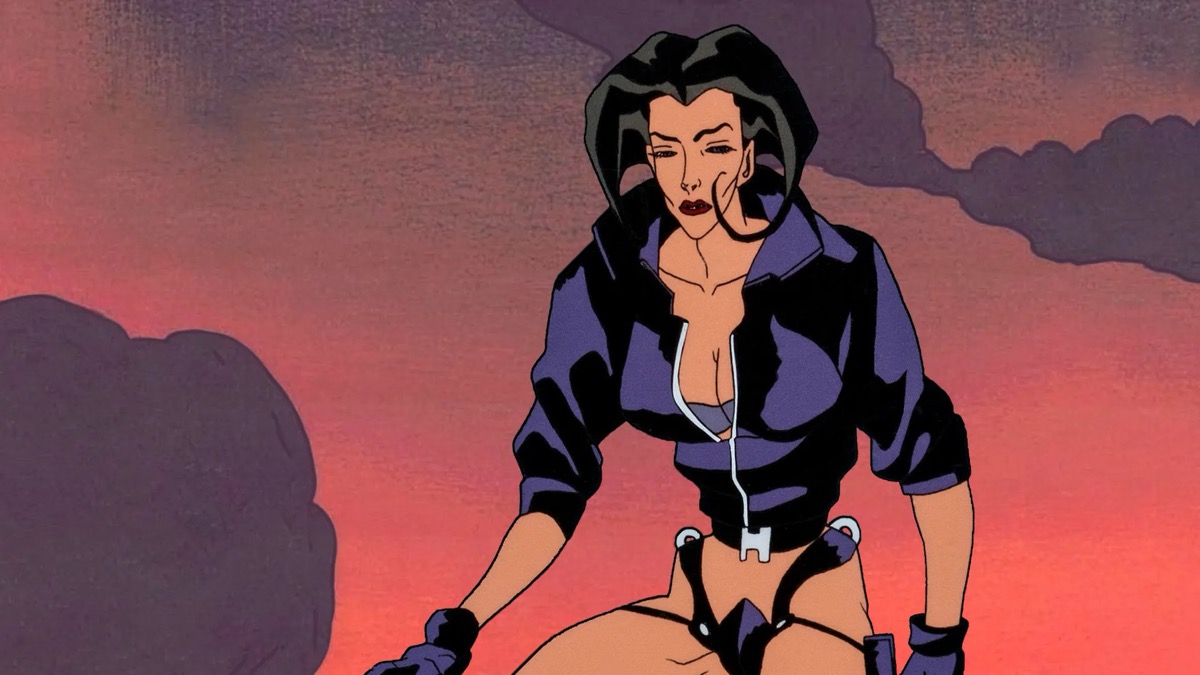 A spy dressed like a dominatrix stands against a sunset sky in "Aeon Flux"