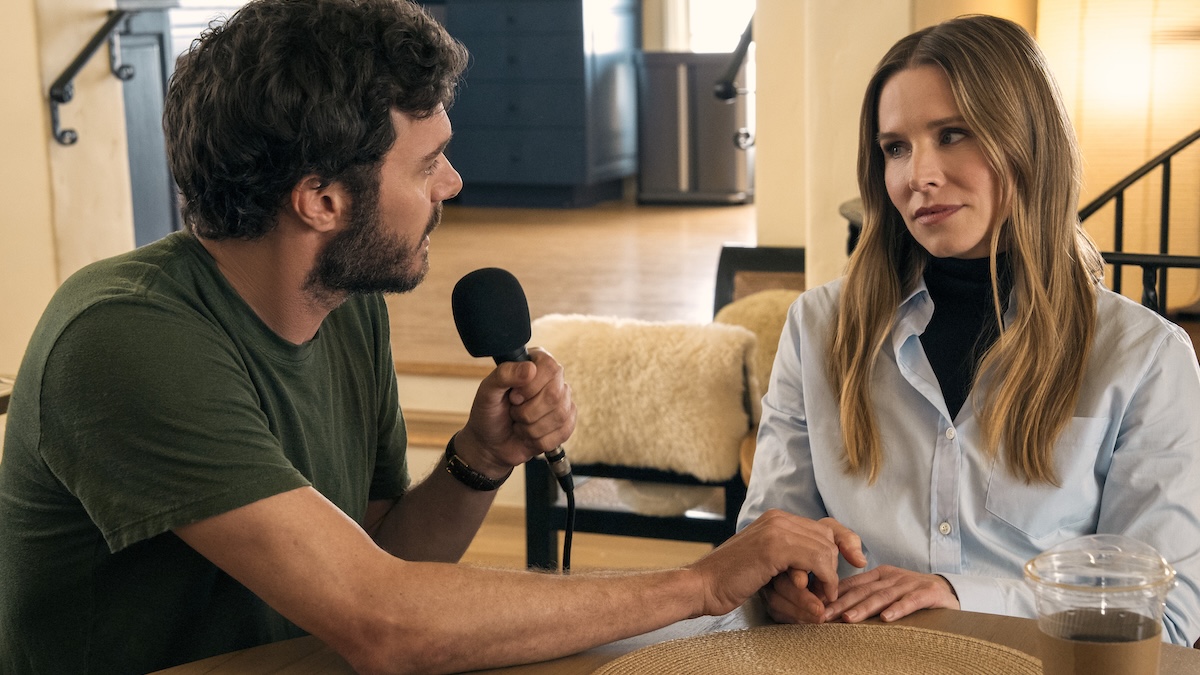 man with mic and woman sitting
