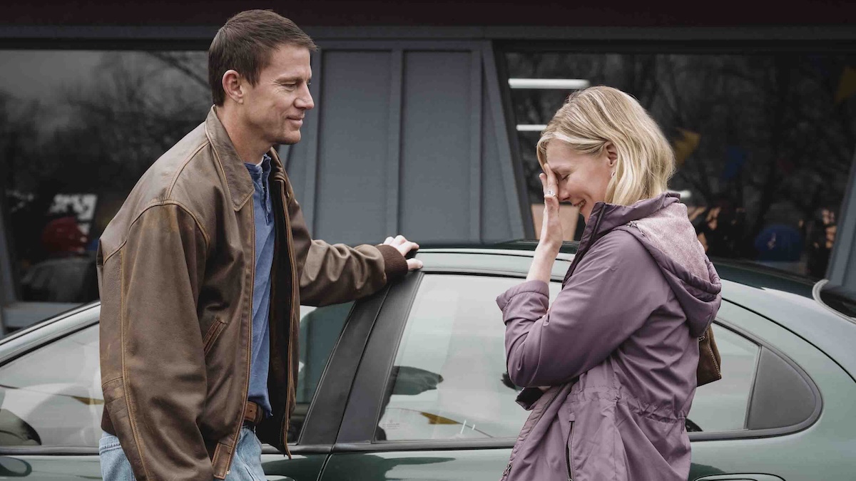 two people standing by a car