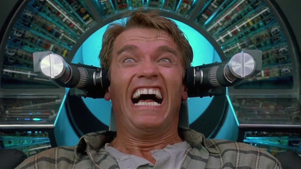 A man attached to a machine grimaces in pain in "Total Recall"