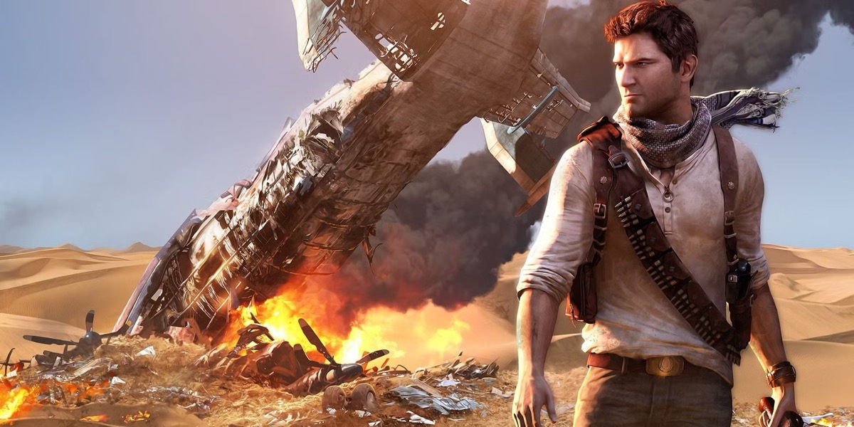 An adventurer stands in front of smoldering wreckage of a plane in the desert in "Uncharted 3" 