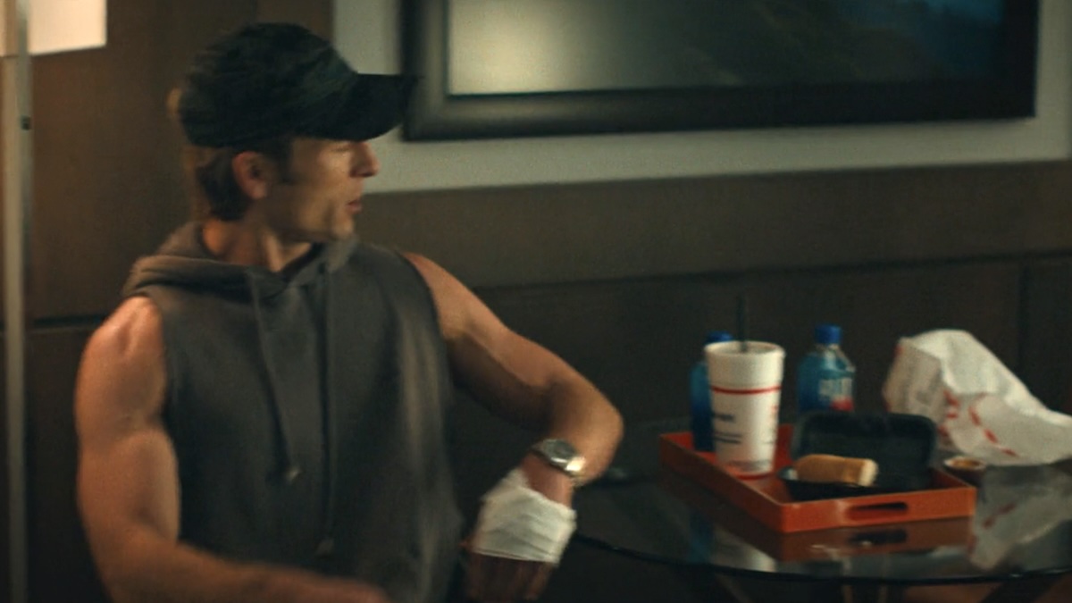 glen powell looking at a cookout cup