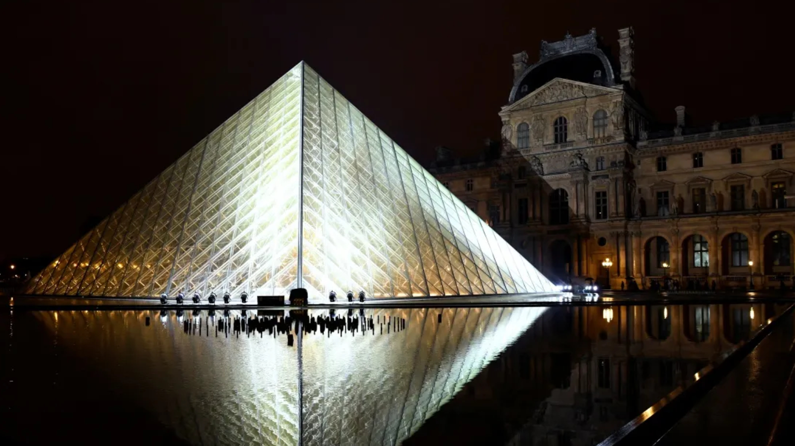 TOPSHOT - The Louvre Pyramid is illuminated in the night, prior to the Louis Vuitton Spring-Summer 2019 Ready-to-Wear collection fashion show in Paris, on October 2, 2018. (Photo by Bertrand GUAY / AFP) (Photo credit should read BERTRAND GUAY/AFP/Getty Images)