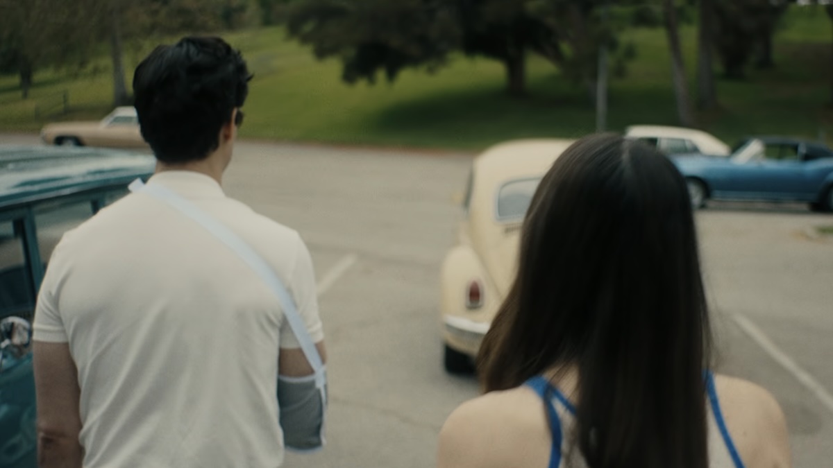 man walking with woman to car