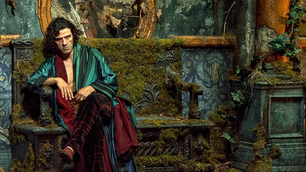 oscar isaac sitting in a chair