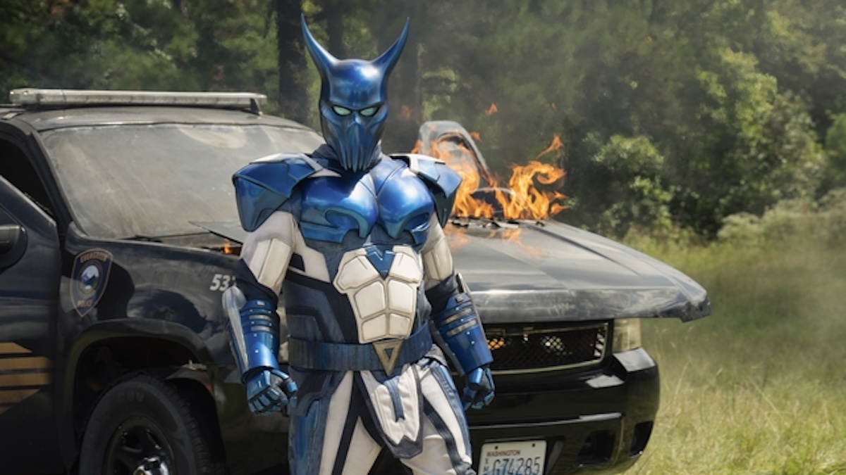 auggie standing in front of a car