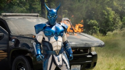 auggie standing in front of a car