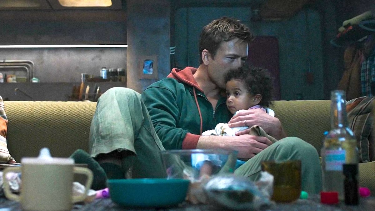 glen powell holding a child