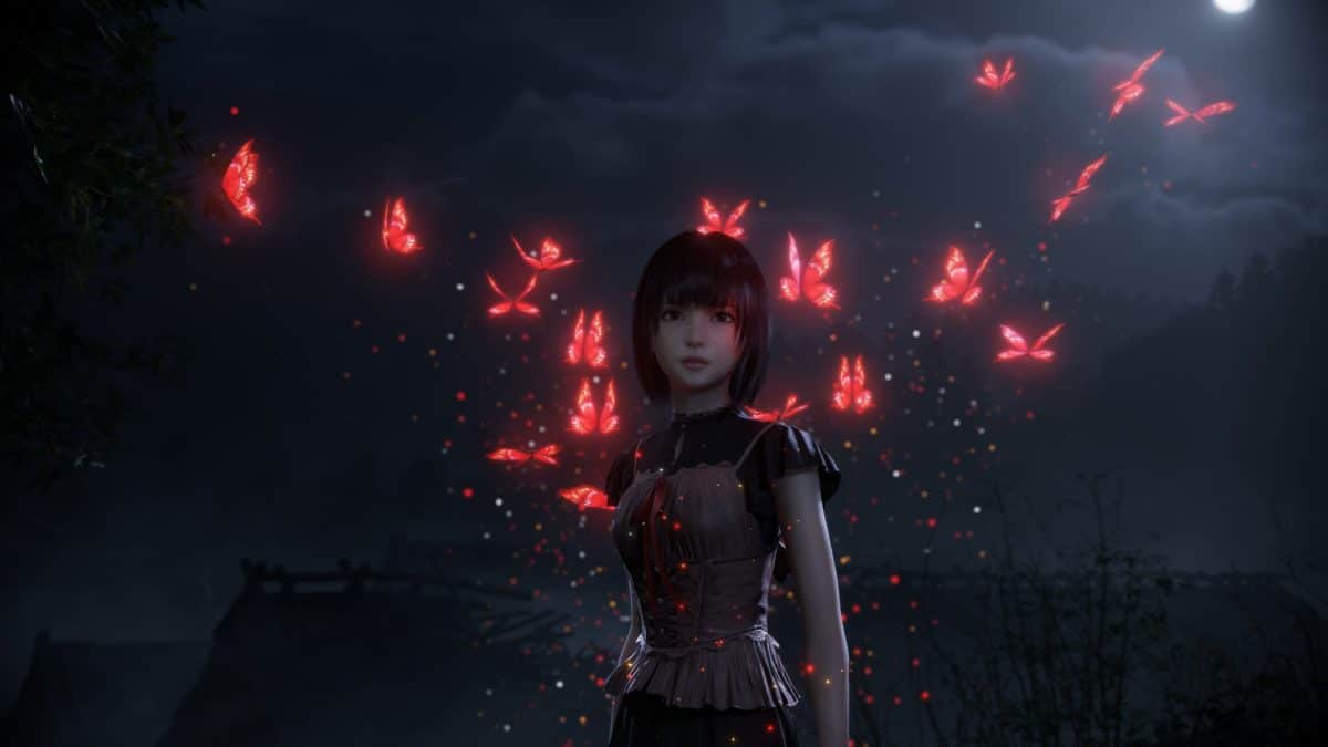 A girl stands in the dark illuminated by ed butterflies in "Fatal Frame 2: Crimson Butterfly" 