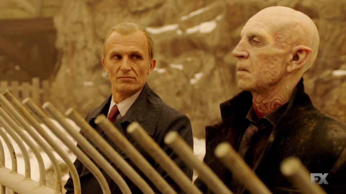 A middle aged man looks at a placid vampire in "The Strain"
