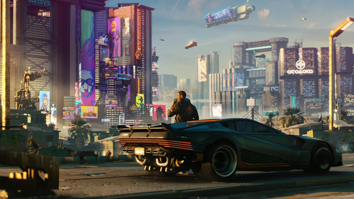 A figure stands on a street in a cyberpunk world in "Cyberpunk 2077"