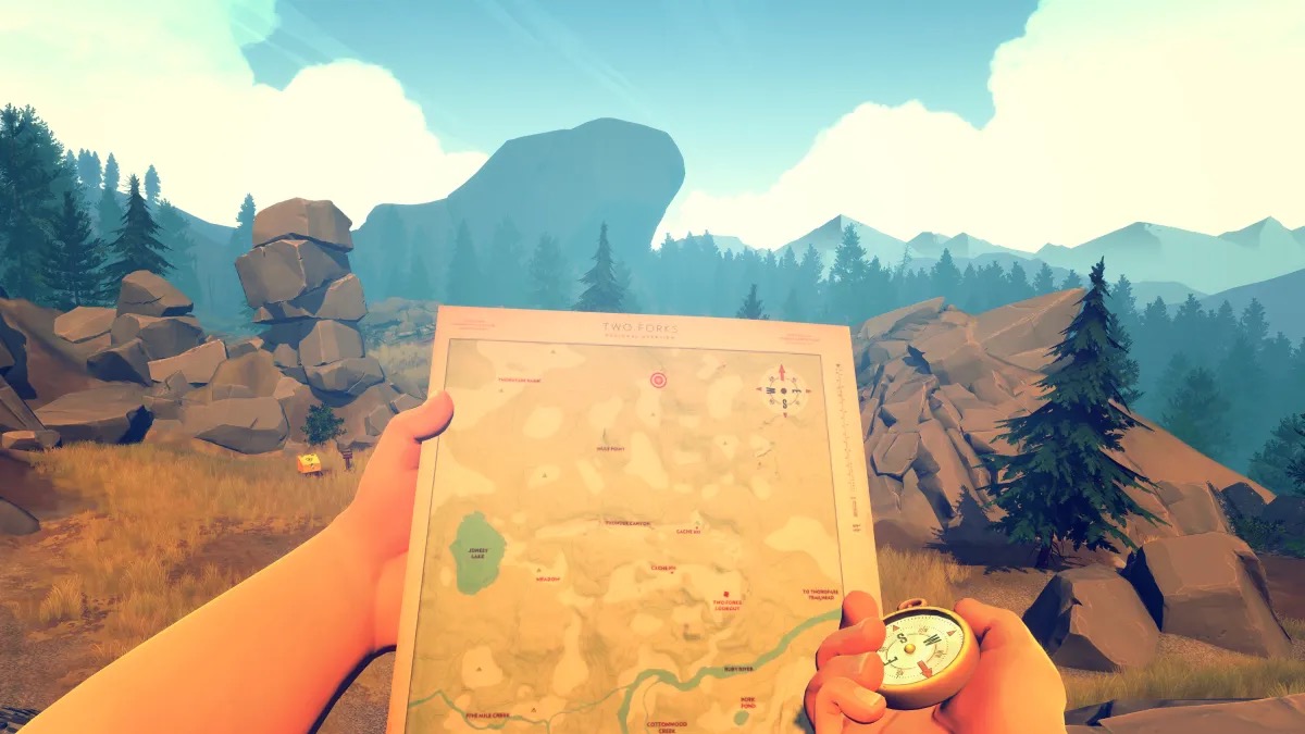 A man draws on a map while looking at a landscape in "Firewatch" 