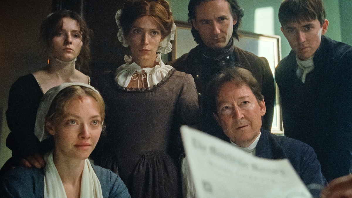 people all sitting looking at paper