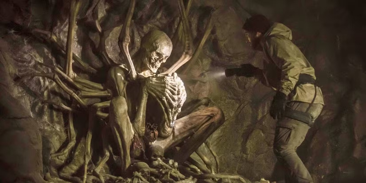 A man with a flashlight examines a skeleton in "The Empty Man"