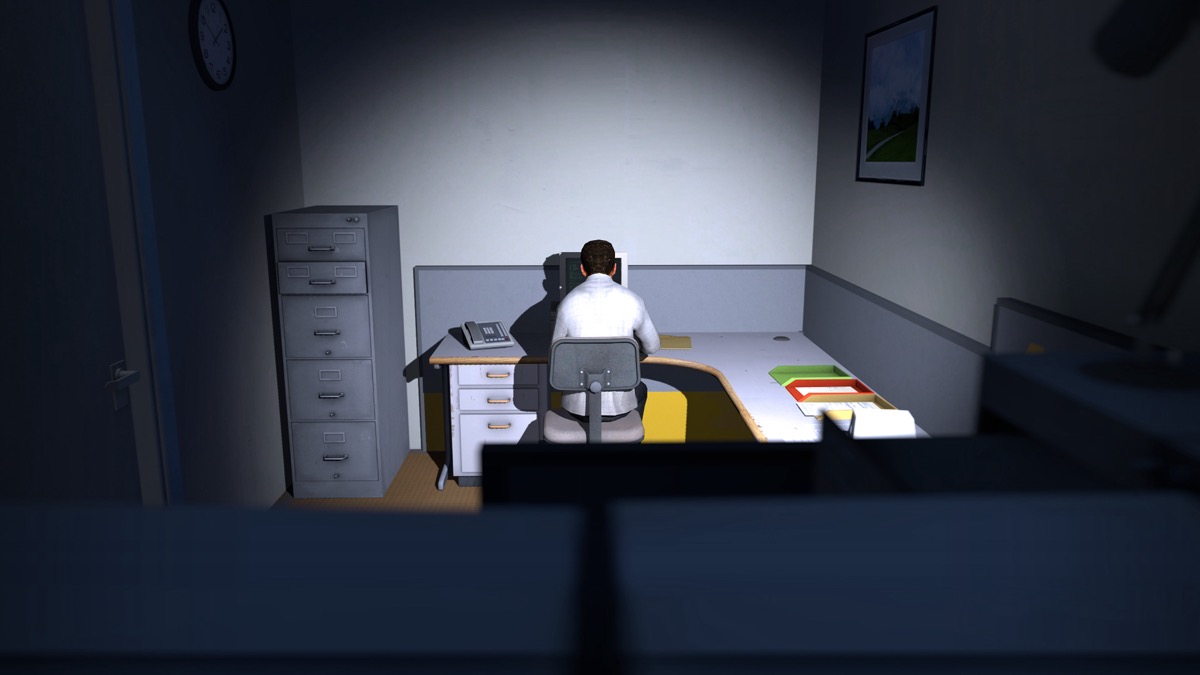 A man works at desk in a solitary office in "The Stanley Parable"