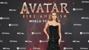 miley cyrus standing on a carpet