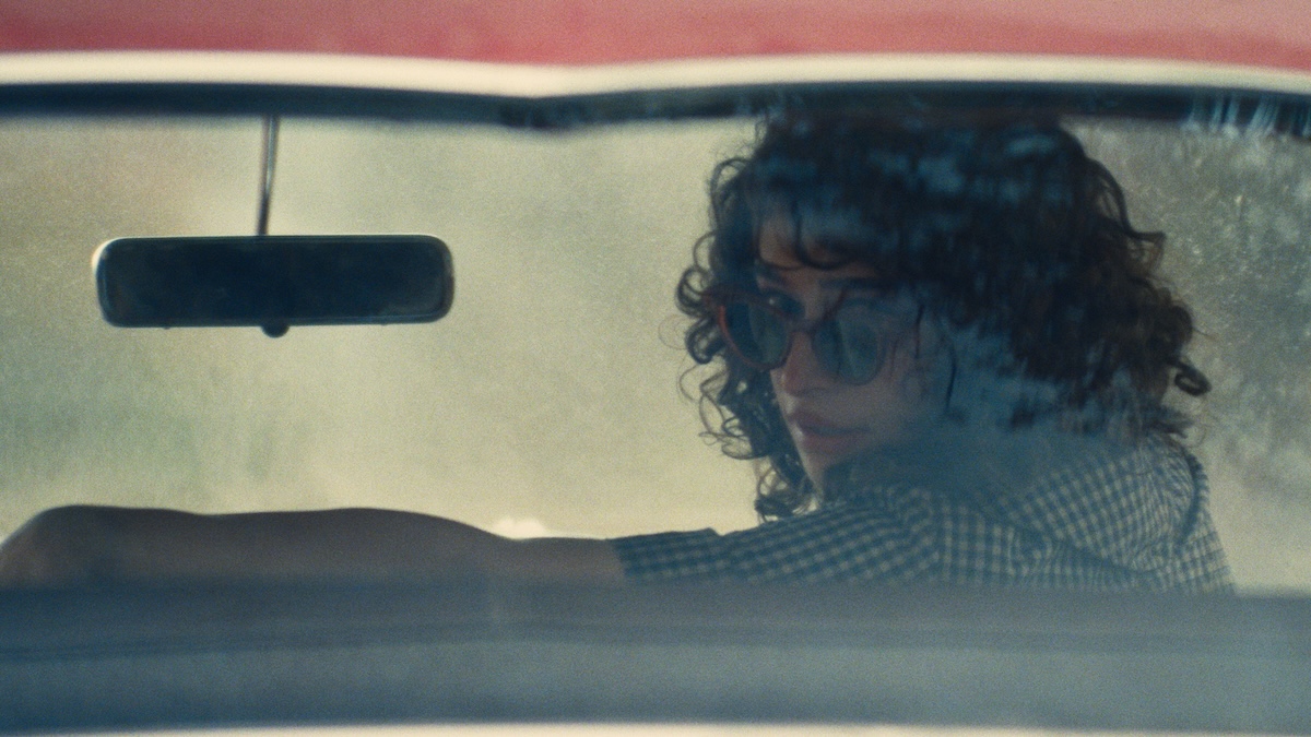 woman looking back in a car