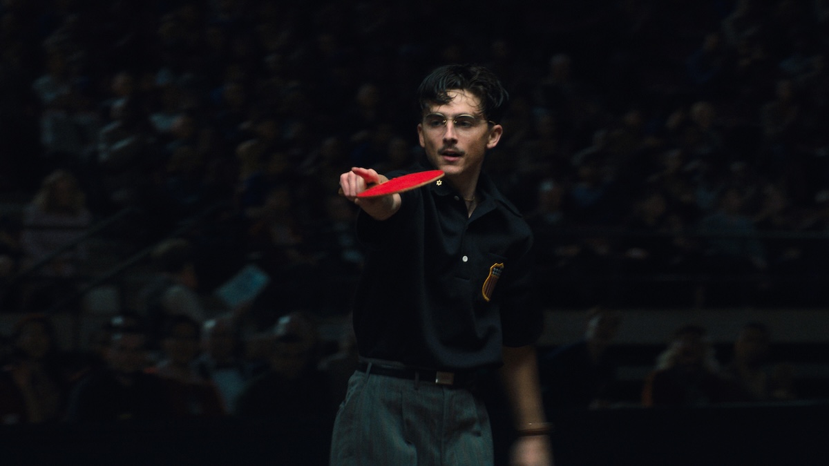 Timmy pointing with a ping pong racket