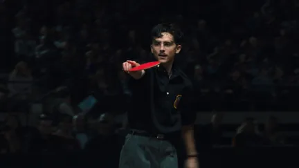 Timmy pointing with a ping pong racket