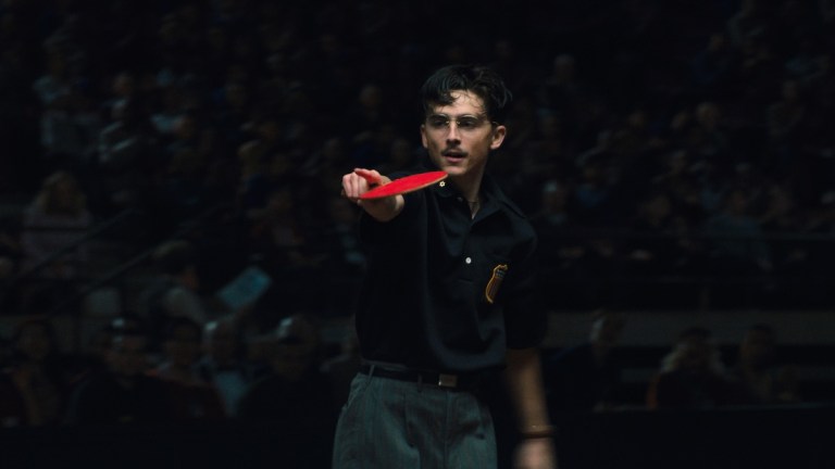 Timmy pointing with a ping pong racket