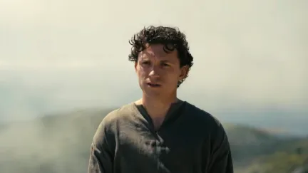 a man standing by the mountains