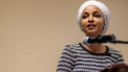 ilhan omar talking at a mic