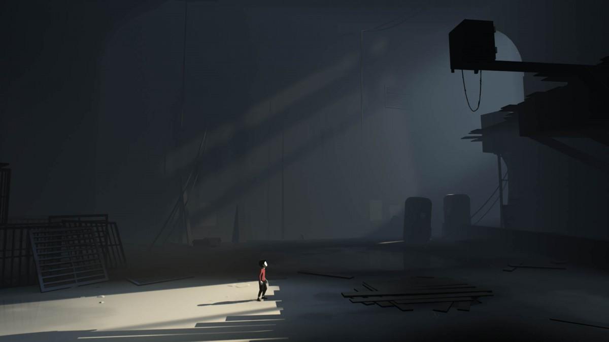A boy in a carvernous space looks up at the ceiling in "Inside"