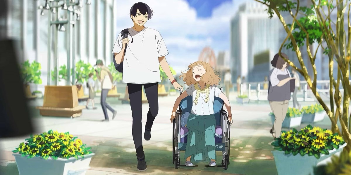 A boy and girl in a wheelchair laugh together on the street in "Josee, The Tiger, and The Fish"