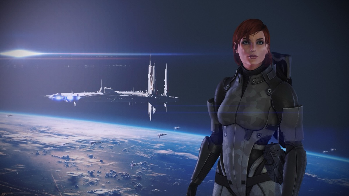 A woman in a space suit is framed by a space station orbiting a planet in "Mass Effect 1" 
