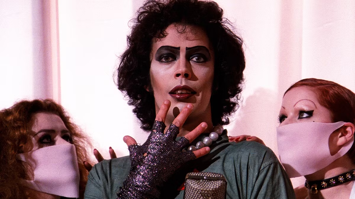 Dr. Frank-N-Furter poses with two nurses in "The Rocky Horror Picture Show"