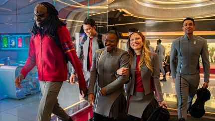 a group of people similing and walking together