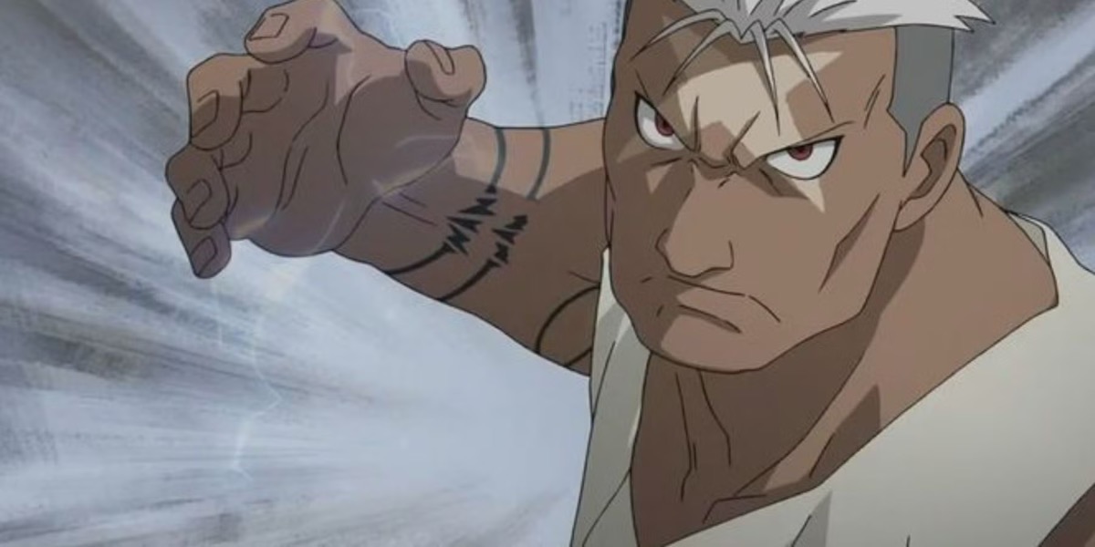 A serious looking man raises his right hand in battle in "Full Metal Alchemist" 