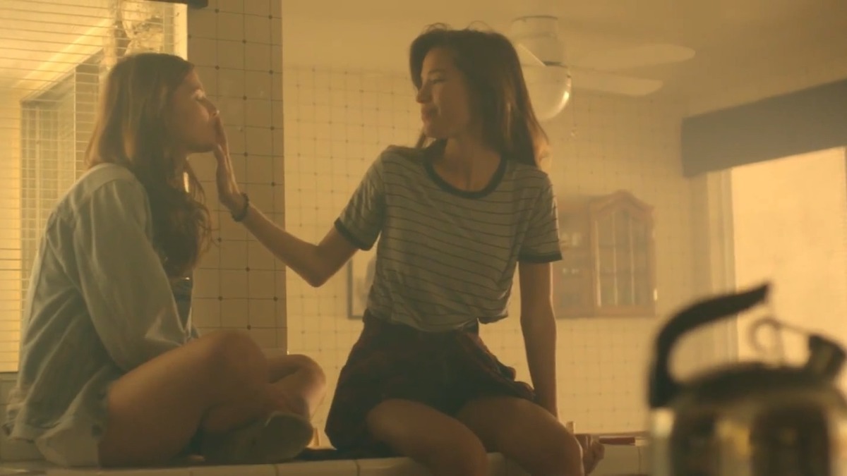 Two girls on a counter in the Girls Like Girls music video