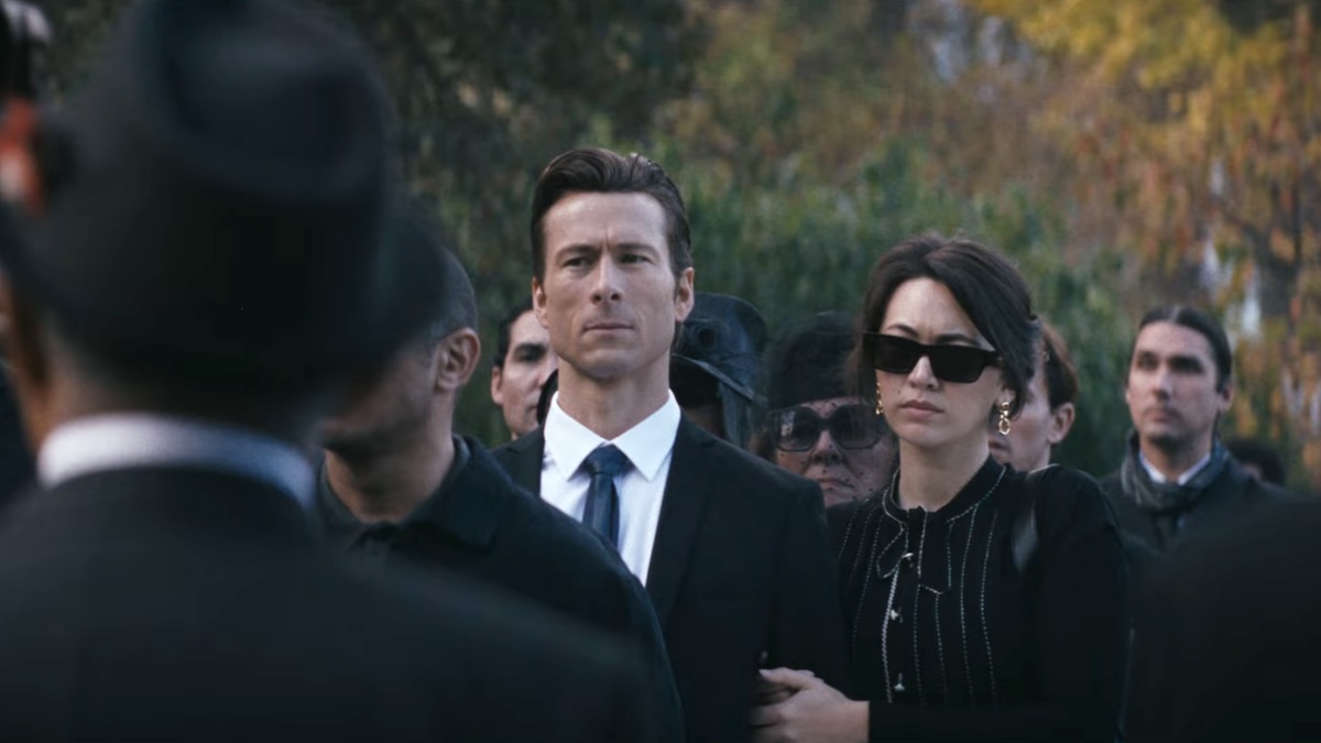 two people standing at a funeral