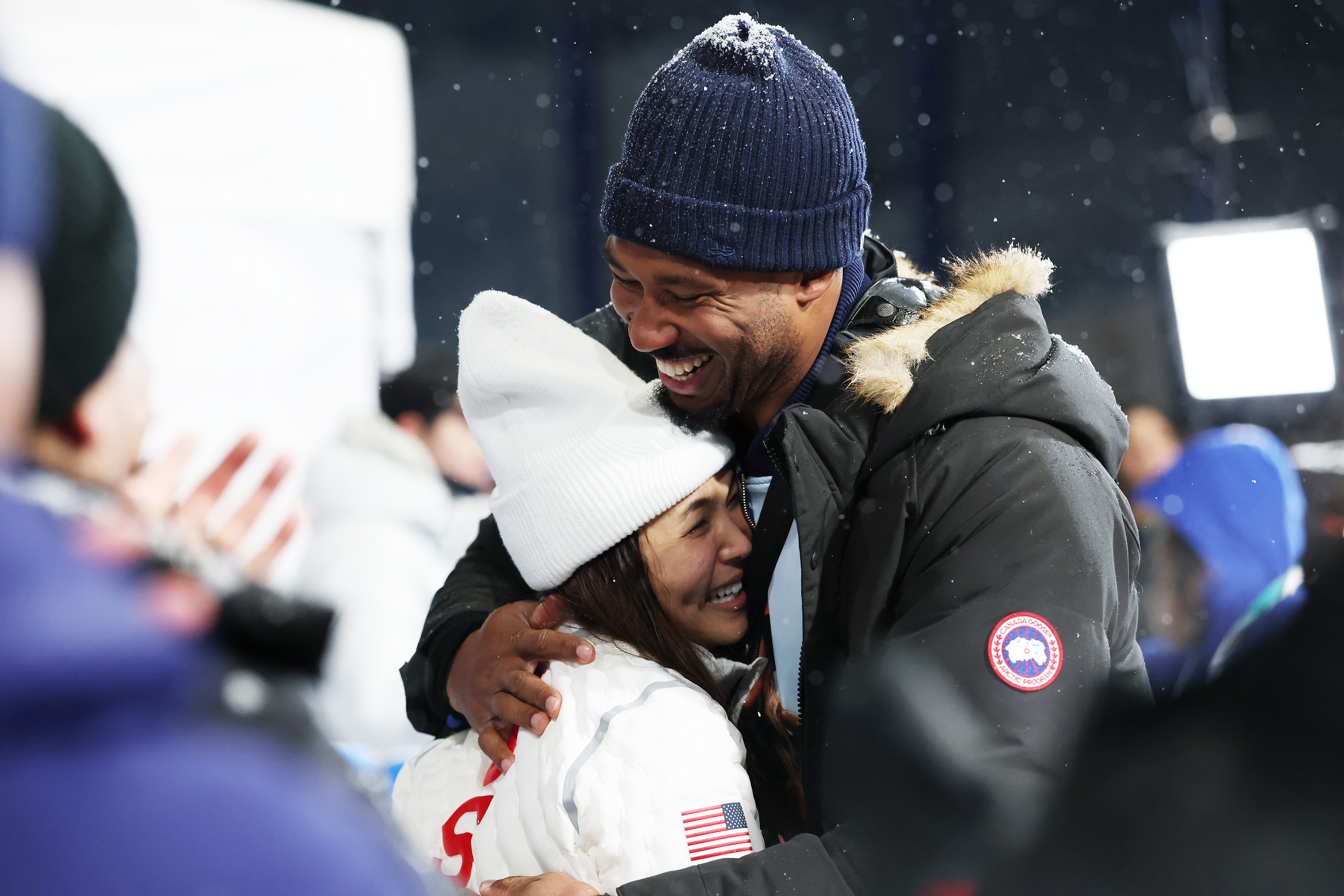 LIVIGNO, ITALY - FEBRUARY 12: Silver medalist Chloe Kim of Team United States celebrates with boy friend Myles Garrett after the Women’s Snowboard Halfpipe on day six of the Milano Cortina 2026 Winter Olympic games at Livigno Snow Park on February 12, 2026 in Livigno, Italy. (Photo by Ian MacNicol/Getty Images)
