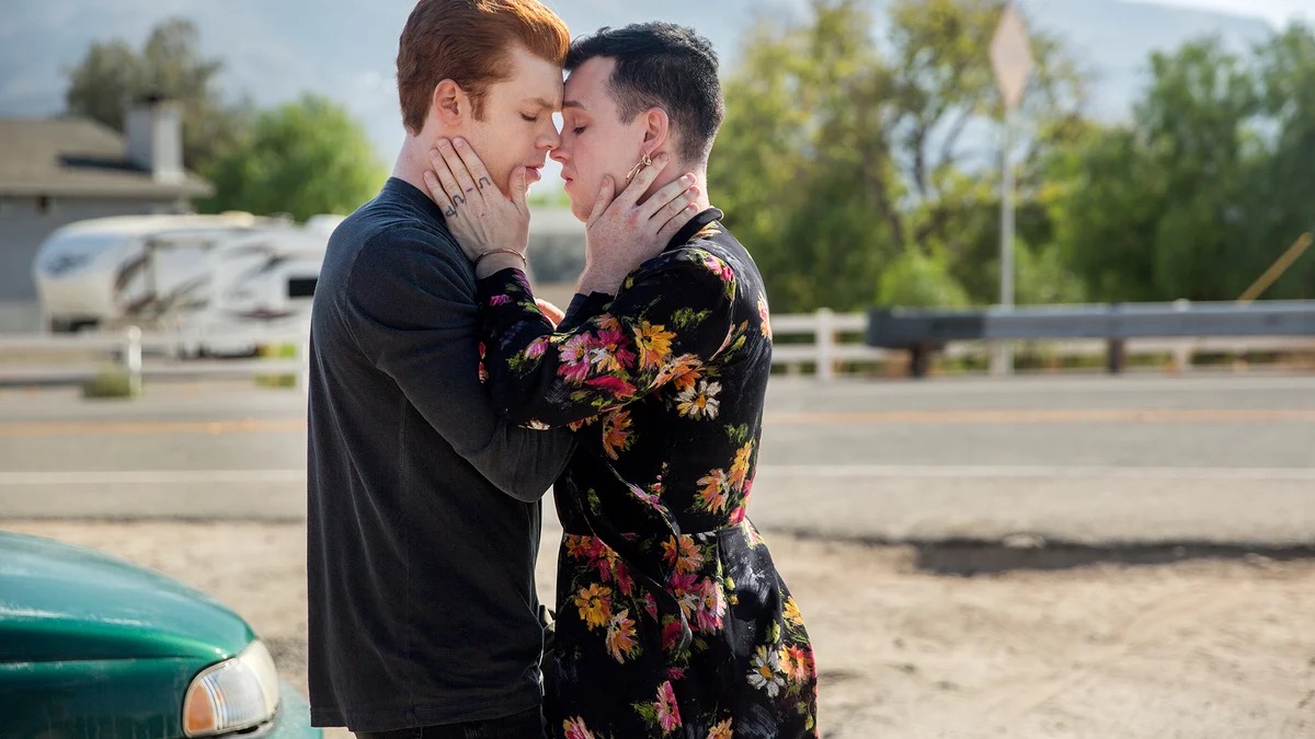 Two young men embrace tenderly in a parking lot in "Shameless"