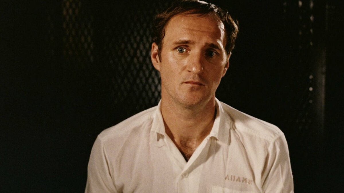 A man with a pained look on his face sits for an interview in "The Thin Blue Line"