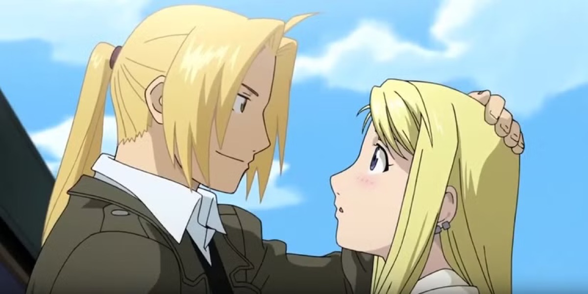Ed and Winry gaze into each others eyes on a train platform in "Fullmetal Alchemist"