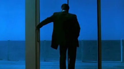 man standing at a window