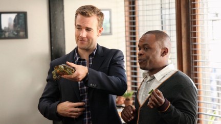James Van Der Beek holding a turtle with his assistant Luther (Ray Ford) on Don't Trust The B