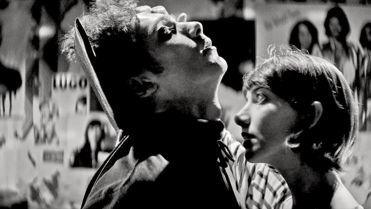 A woman prepares to bite the neck of a man dressed as Dracula in "A Girl Walks Home Alone at Night" 