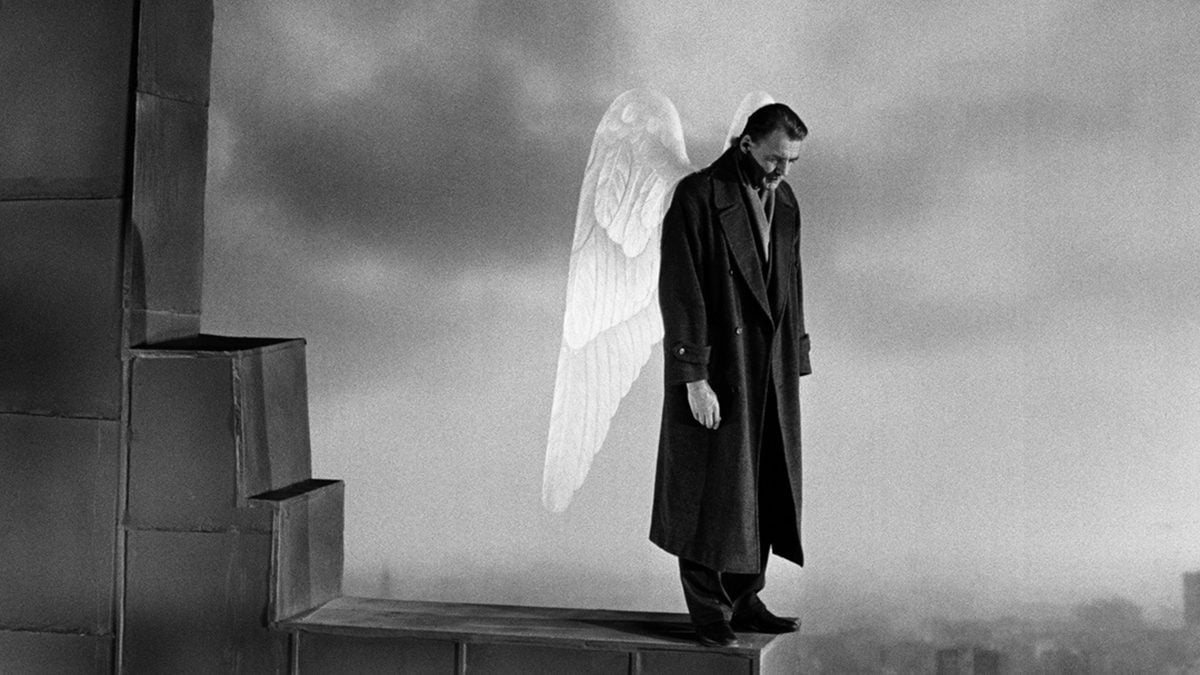 An angel looks down from a rooftop in "Wings of Desire"