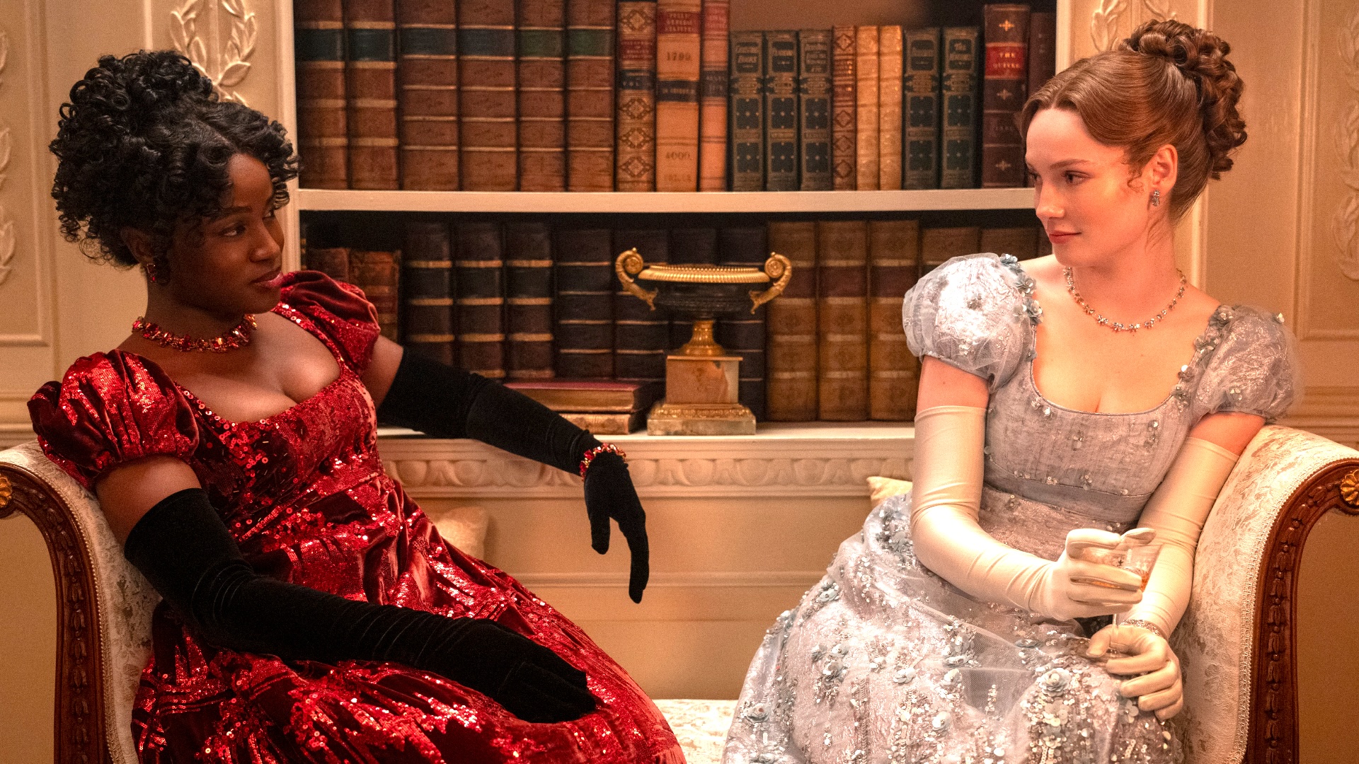 bridgerton couple sitting on a couch