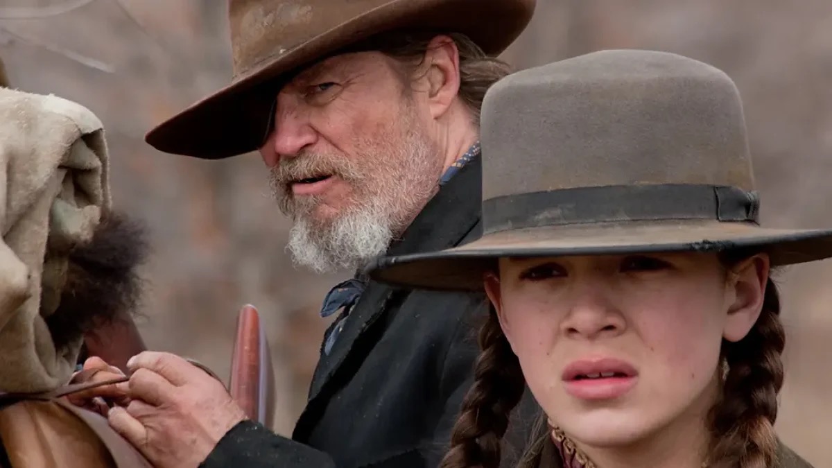A girl and an old man prepare to saddle up in "True Grit"