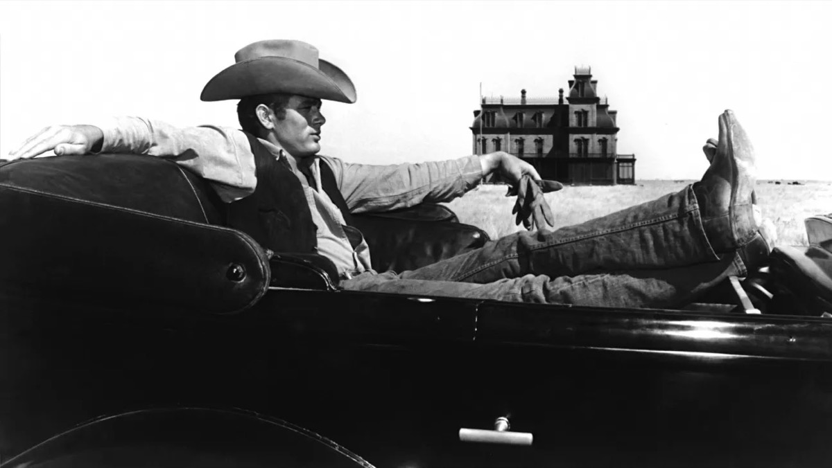 A handsome cowboy reclines in a car in Giant