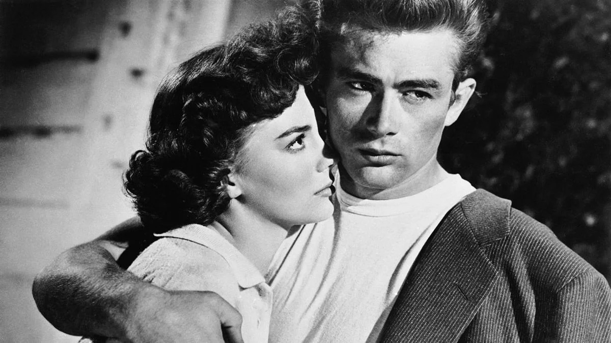 A man glares cooly while holding a woman in "Rebel Without a Cause"