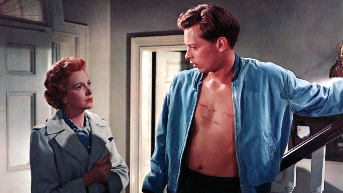 A man with an open shirt talks to a woman in Tea and Sympathy