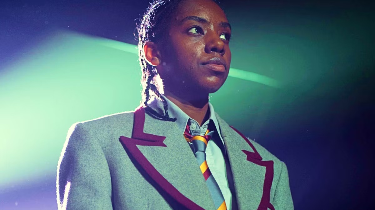 Cal Bowman stands confidently in Sex Education