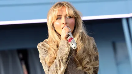 sabrina carpenter sitting on a stage